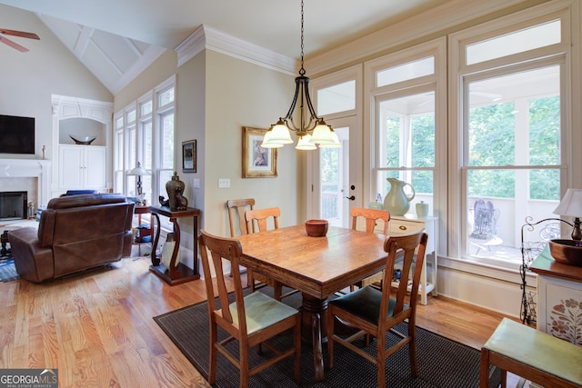 8440 Woodland Brooke Trl, Cumming, GA 30028 - dining room featuring light wood-type flooring, healthy amount of natural light, baseboards, lofted ceiling, and ornamental molding
