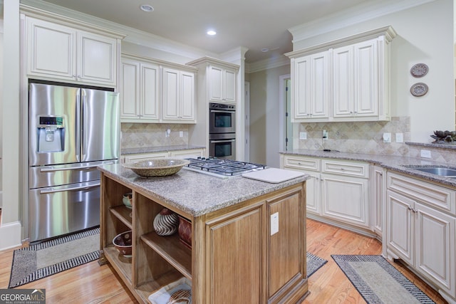 8440 Woodland Brooke Trl, Cumming, GA 30028 - kitchen featuring appliances with stainless steel finishes, open shelves, a kitchen island, tasteful backsplash, and light wood-type flooring