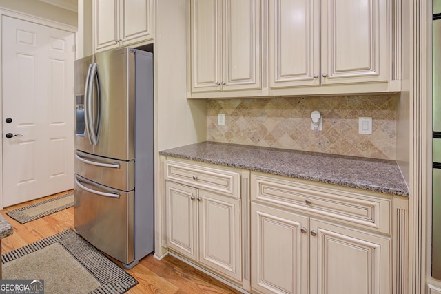 8440 Woodland Brooke Trl, Cumming, GA 30028 - kitchen featuring cream cabinetry, stainless steel fridge with ice dispenser, light wood-style floors, tasteful backsplash, and ornamental molding