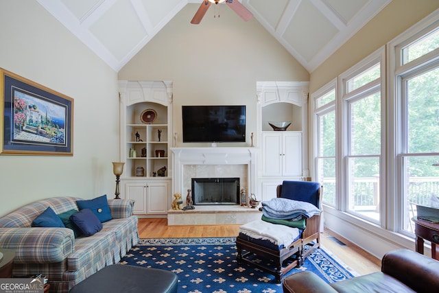 8440 Woodland Brooke Trl, Cumming, GA 30028 - living area with plenty of natural light, high vaulted ceiling, light wood-type flooring, ceiling fan, and a fireplace
