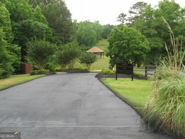 exterior space featuring a yard and aphalt driveway