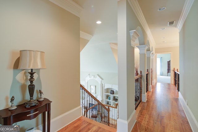 8440 Woodland Brooke Trl, Cumming, GA 30028 - hall featuring an upstairs landing, wood finished floors, ornamental molding, recessed lighting, and baseboards