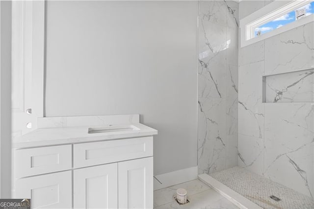 full bathroom with marble finish floor, a shower stall, and vanity