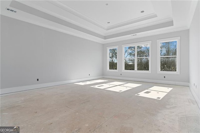 empty room featuring visible vents, baseboards, a raised ceiling, and ornamental molding