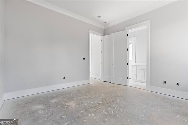 unfurnished bedroom with ornamental molding, ensuite bath, baseboards, and unfinished concrete floors