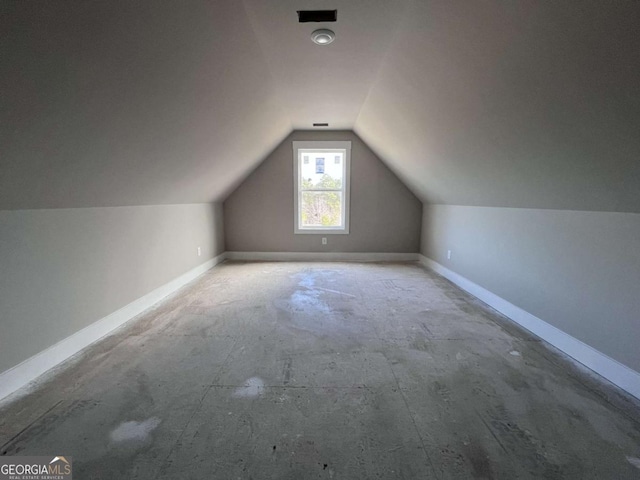 bonus room featuring lofted ceiling and baseboards