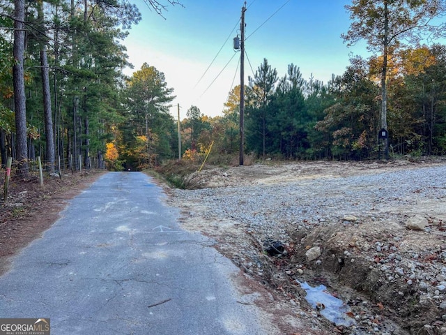 view of road with a wooded view