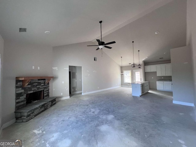 unfurnished living room with baseboards, unfinished concrete flooring, ceiling fan, a fireplace, and high vaulted ceiling