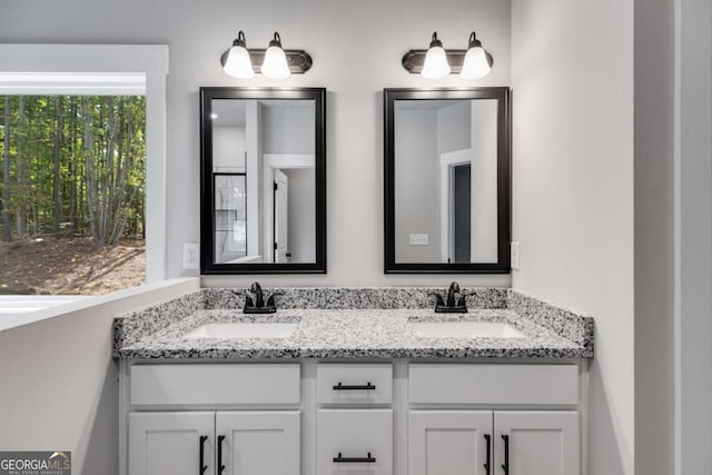 full bathroom featuring a sink and double vanity