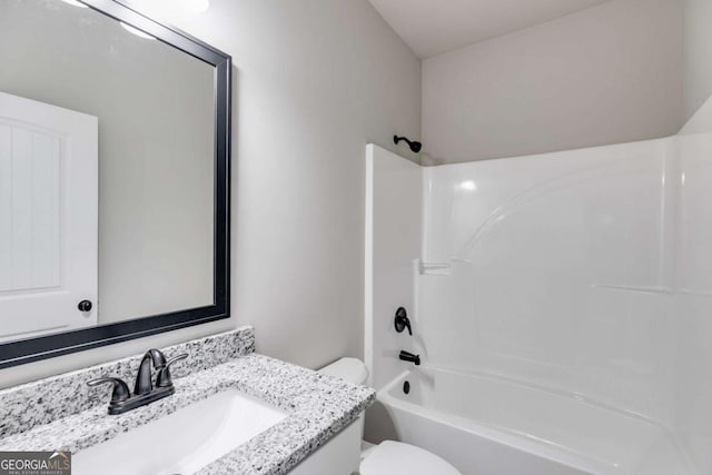 full bathroom featuring tub / shower combination, vanity, and toilet