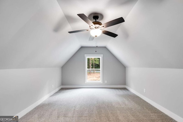 bonus room with lofted ceiling, carpet, baseboards, and ceiling fan