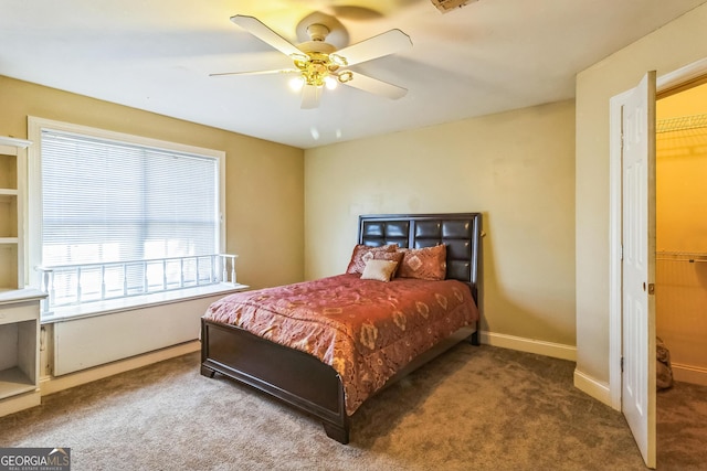 carpeted bedroom featuring ceiling fan, visible vents, and baseboards