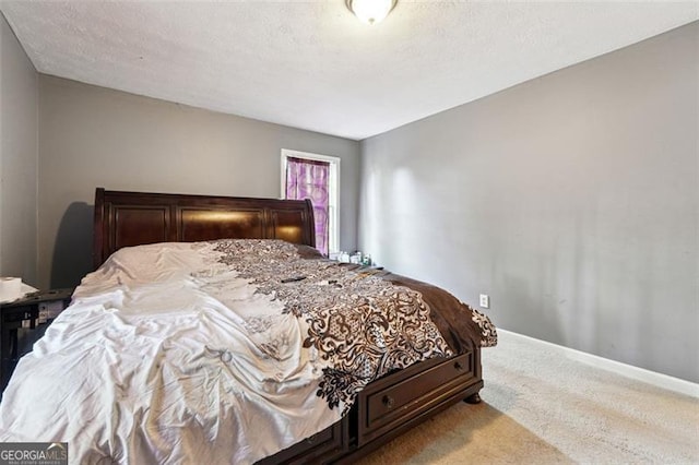 bedroom featuring light carpet, a textured ceiling, and baseboards