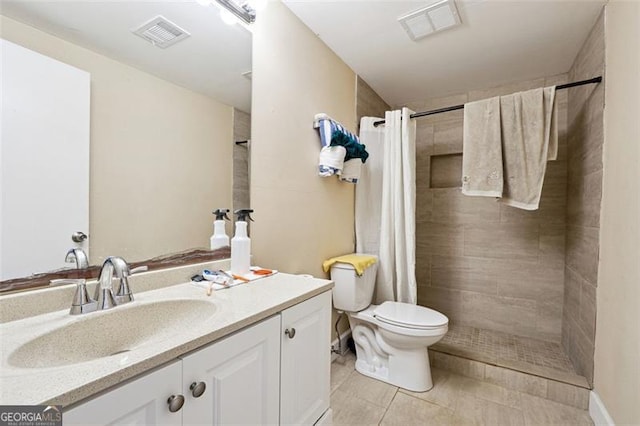 bathroom featuring toilet, tile patterned floors, visible vents, and vanity