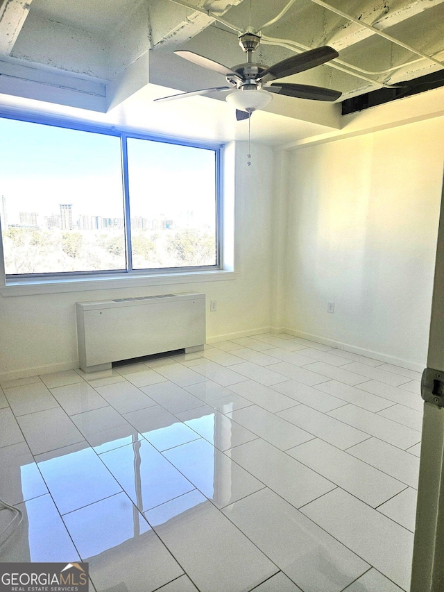 2479 Peachtree Rd NE Unit 1115, Atlanta, GA 30305 - tiled spare room with healthy amount of natural light, radiator heating unit, ceiling fan, and baseboards
