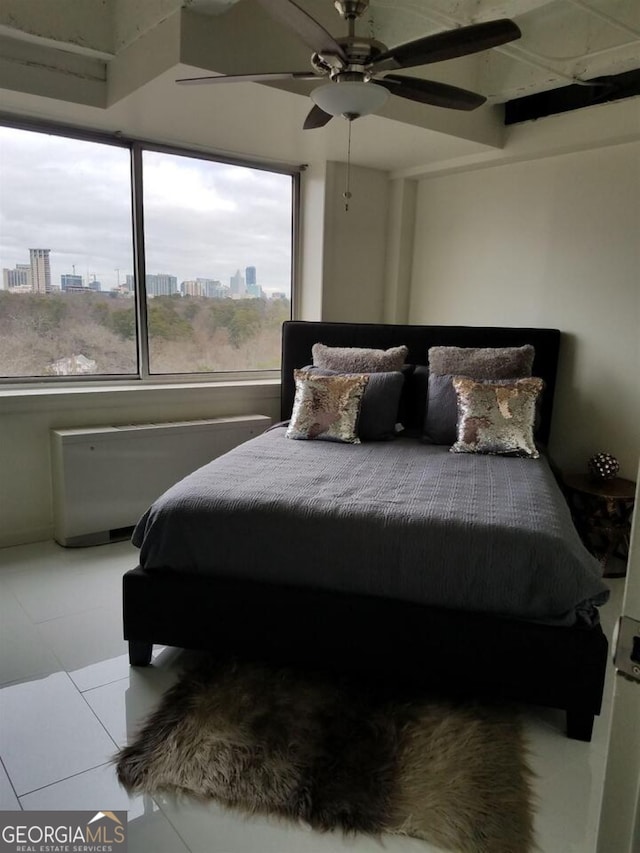 2479 Peachtree Rd NE Unit 1115, Atlanta, GA 30305 - bedroom with multiple windows, a view of city, radiator heating unit, and ceiling fan