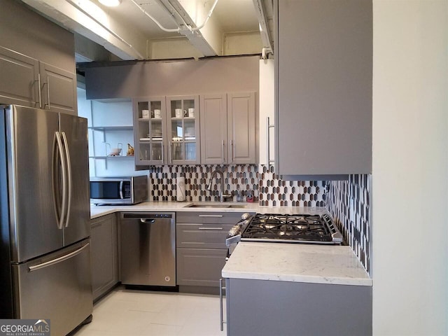 2479 Peachtree Rd NE Unit 1115, Atlanta, GA 30305 - kitchen with stainless steel appliances, gray cabinetry, a sink, and tasteful backsplash