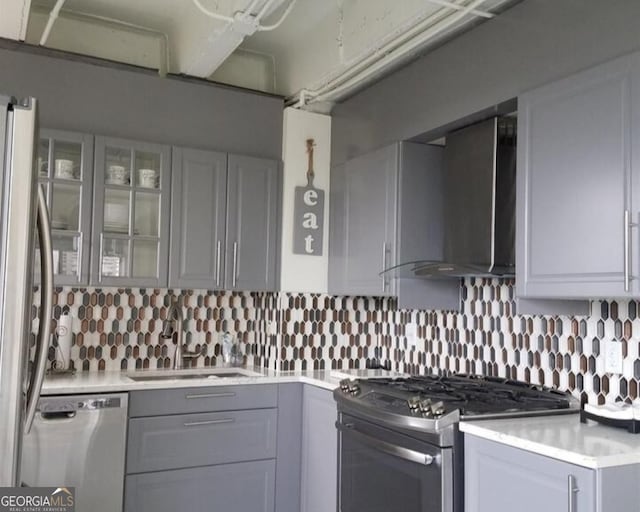 2479 Peachtree Rd NE Unit 1115, Atlanta, GA 30305 - kitchen with appliances with stainless steel finishes, wall chimney range hood, a sink, gray cabinetry, and light countertops