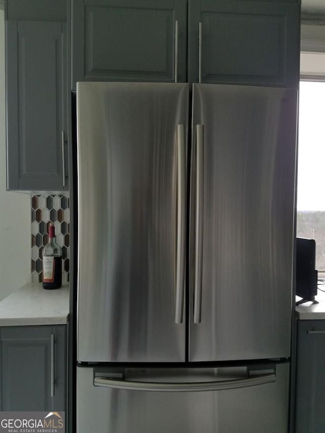 2479 Peachtree Rd NE Unit 1115, Atlanta, GA 30305 - kitchen view of freestanding refrigerator, light countertops, and decorative backsplash