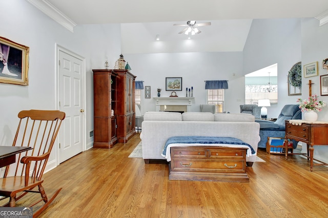 bedroom with crown molding, light wood-type flooring, vaulted ceiling, and a fireplace