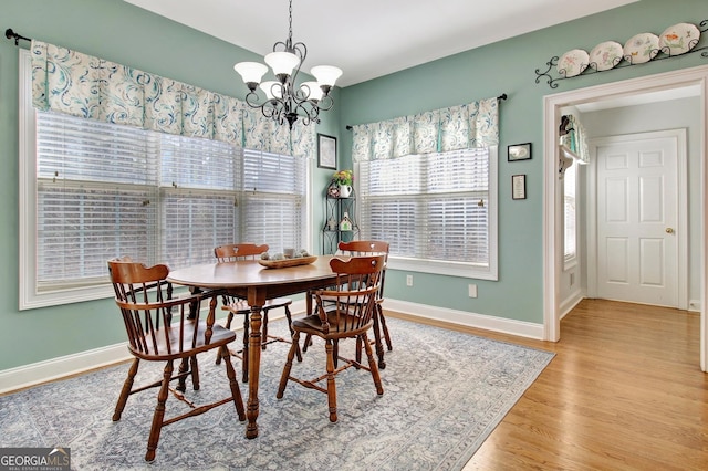 dining room featuring a wealth of natural light, baseboards, and light wood finished floors