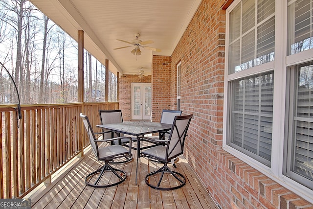 deck with a ceiling fan, french doors, and outdoor dining area