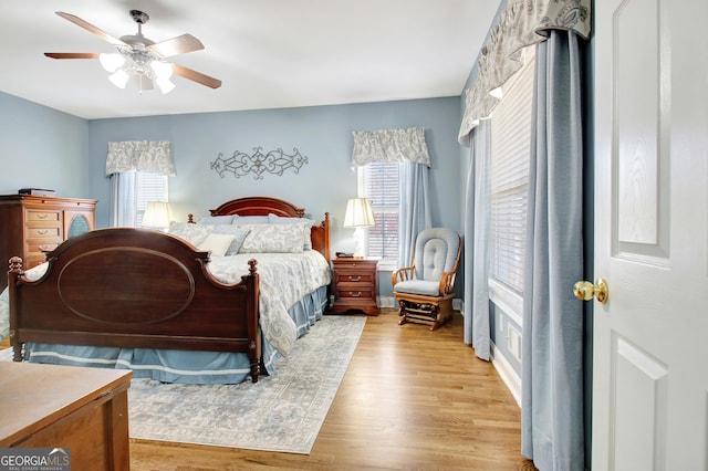 bedroom with a ceiling fan and light wood-style floors