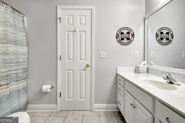 full bathroom featuring tile patterned flooring, baseboards, vanity, and toilet