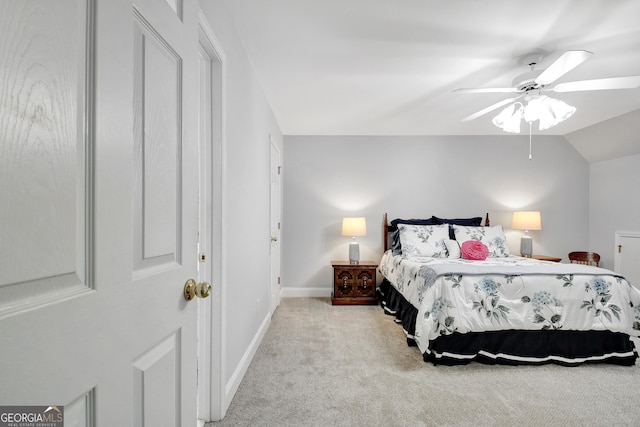 bedroom featuring a ceiling fan, lofted ceiling, light colored carpet, and baseboards