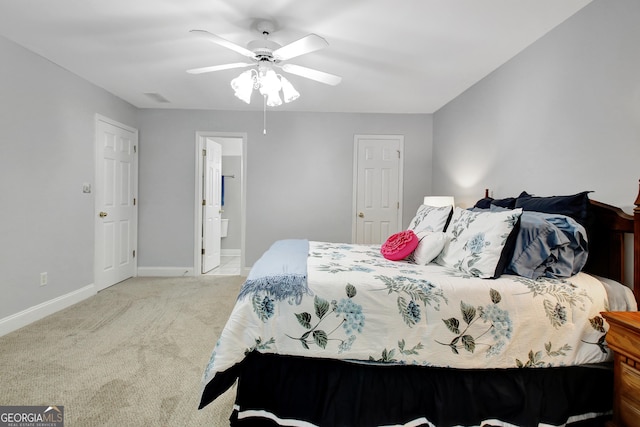 bedroom featuring ceiling fan, connected bathroom, light carpet, visible vents, and baseboards