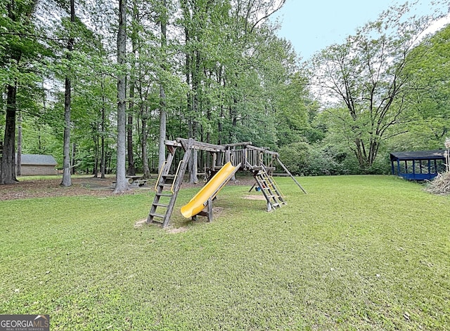 view of jungle gym featuring a lawn