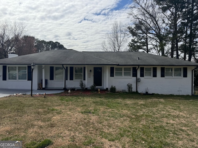 ranch-style house featuring a front yard, crawl space, brick siding, and a chimney