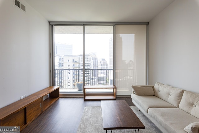 living area featuring visible vents, dark wood-style flooring, and a city view