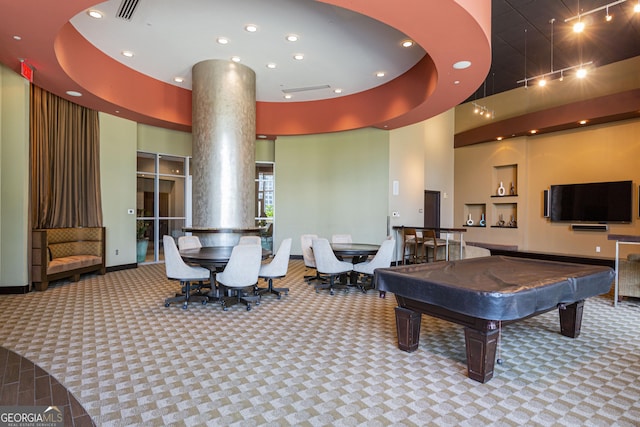 game room featuring track lighting, carpet, baseboards, and a high ceiling