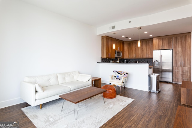 living room with recessed lighting, dark wood finished floors, visible vents, and baseboards