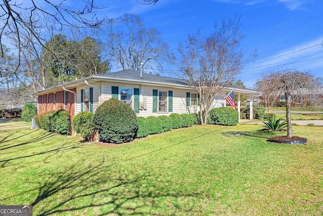 ranch-style home featuring brick siding and a front lawn