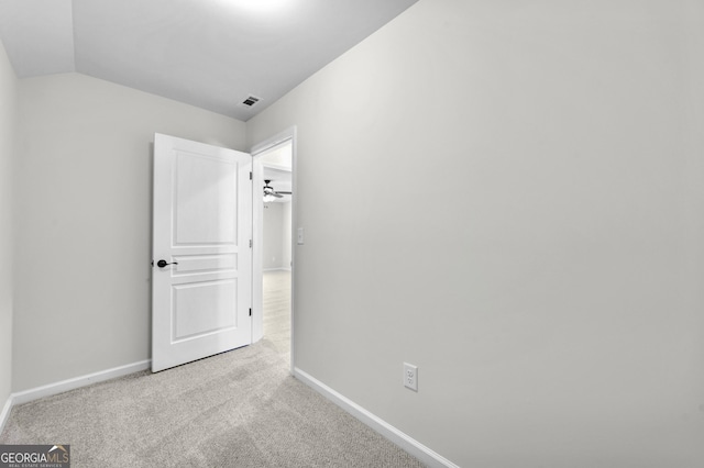 unfurnished bedroom featuring vaulted ceiling, carpet, visible vents, and baseboards