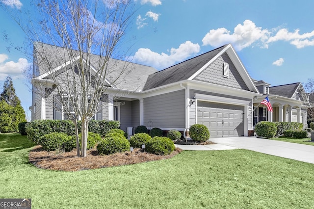 view of front of house featuring a garage, driveway, and a front yard