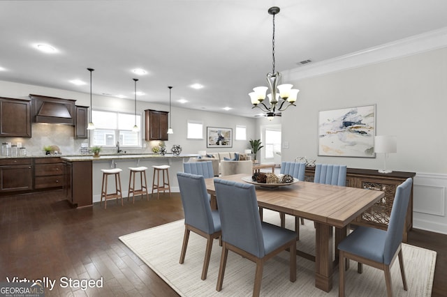 dining room with dark wood-style flooring, a wainscoted wall, recessed lighting, visible vents, and ornamental molding