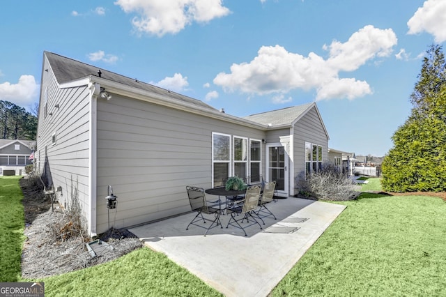 rear view of property with a patio area and a lawn