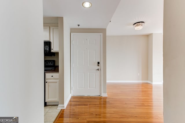 interior space with light wood-type flooring and baseboards