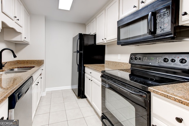 kitchen with light tile patterned floors, a sink, white cabinetry, baseboards, and black appliances