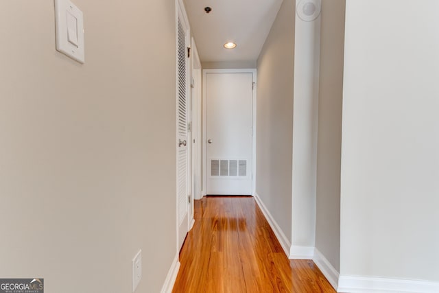 hall featuring recessed lighting, light wood-type flooring, visible vents, and baseboards