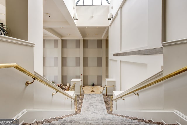 staircase with coffered ceiling