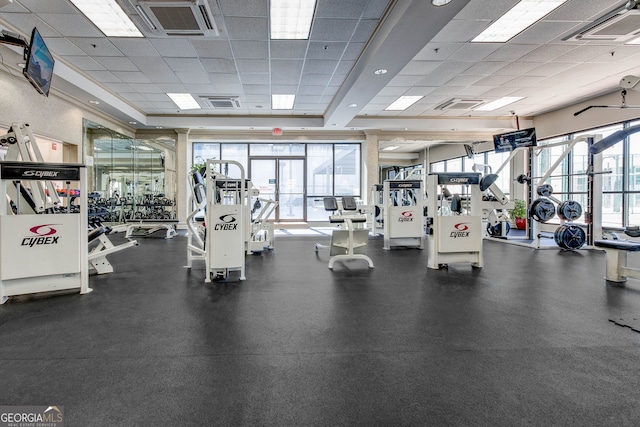 workout area featuring plenty of natural light, visible vents, and a drop ceiling