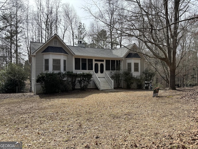 single story home featuring a chimney