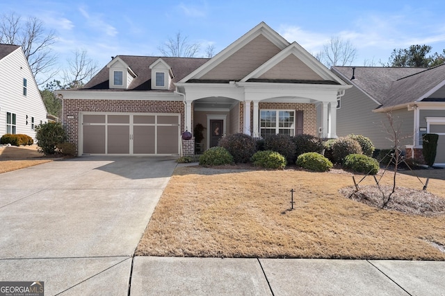 craftsman inspired home featuring concrete driveway, brick siding, and an attached garage