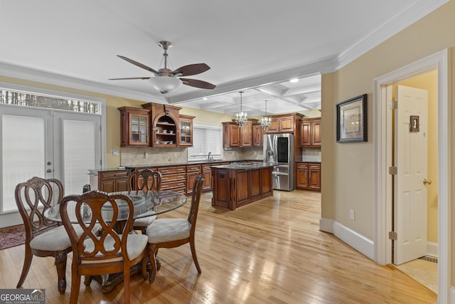 dining room featuring beam ceiling, coffered ceiling, baseboards, and light wood finished floors