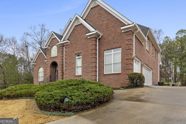 view of front of home with concrete driveway and brick siding