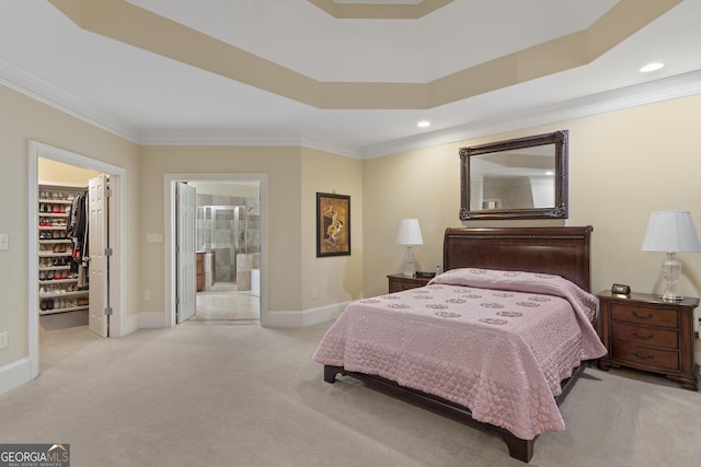 bedroom featuring a walk in closet, crown molding, a closet, light carpet, and baseboards